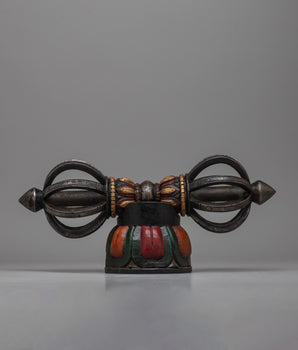  The Tibetan Vajra on Wooden Stand is a stunning combination of traditional workmanship and artistic flair, precisely crafted from iron and painted with acrylic.