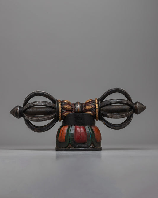  The Tibetan Vajra on Wooden Stand is a stunning combination of traditional workmanship and artistic flair, precisely crafted from iron and painted with acrylic.